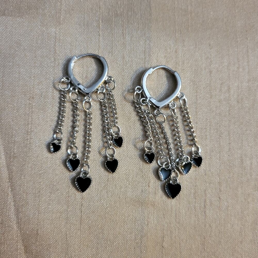Silver tone mini hoop earrings with black heart charms
